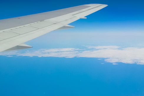 ViewOfEarthFromAirplaneWindowAtWing